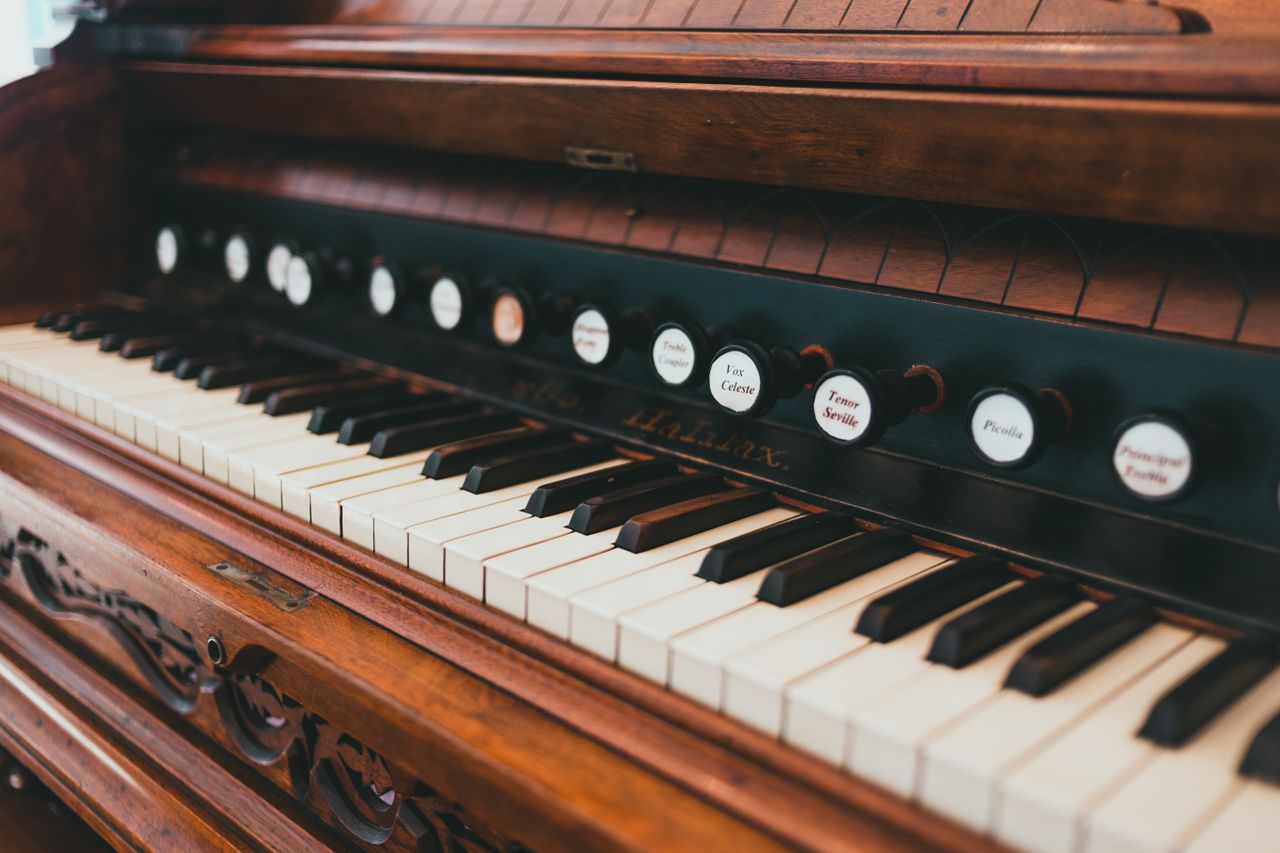 Detailed view of vintage wooden piano keys showcasing intricate craftsmanship.
